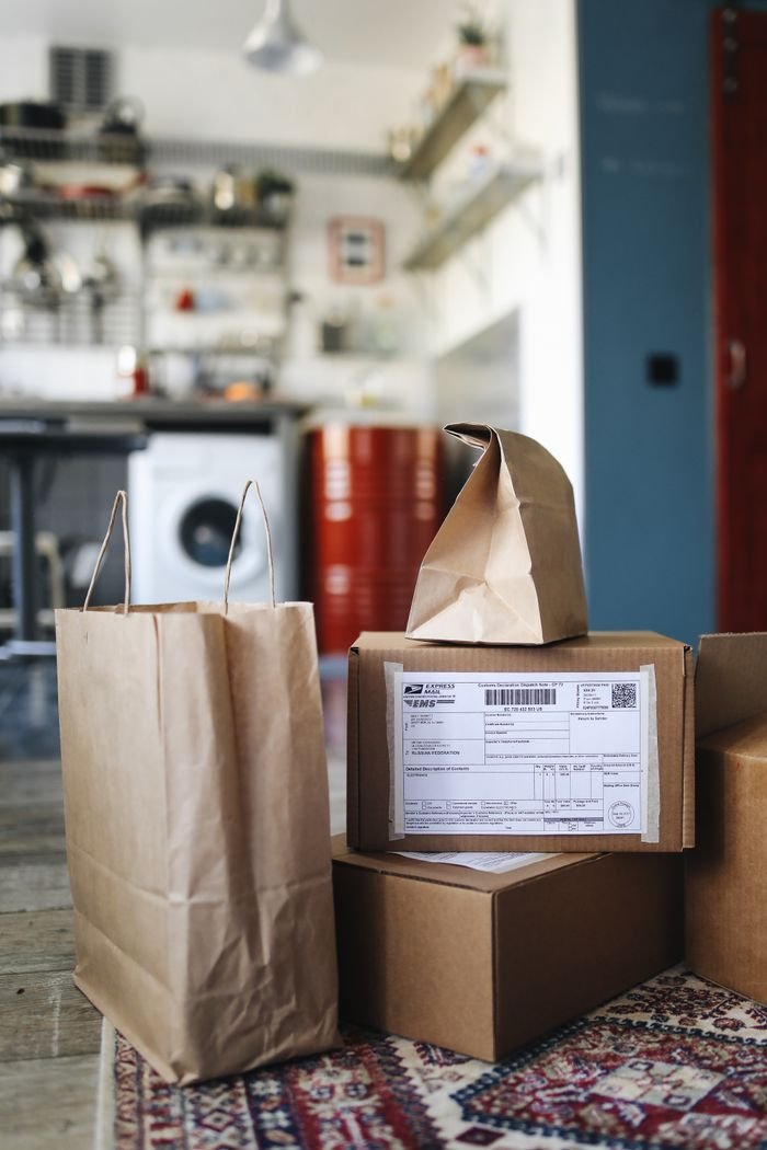 Services Packages and bags from online shopping in a contemporary kitchen setting.